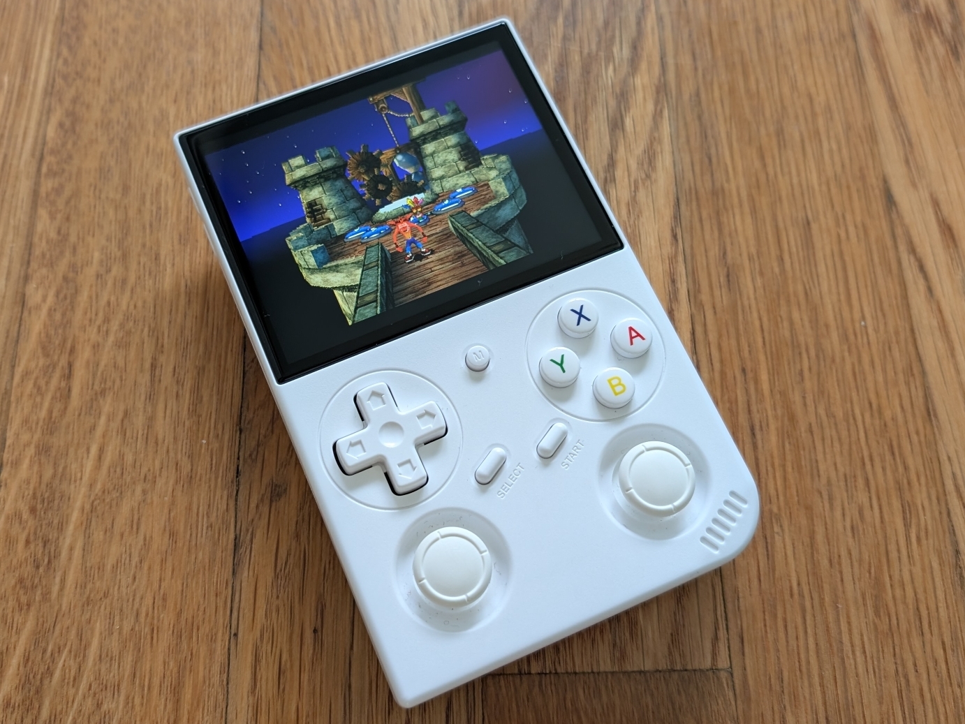 Handheld retro console Anbernic RG35XX Pro, with Crash Bandicoot 3: Warped booted up.