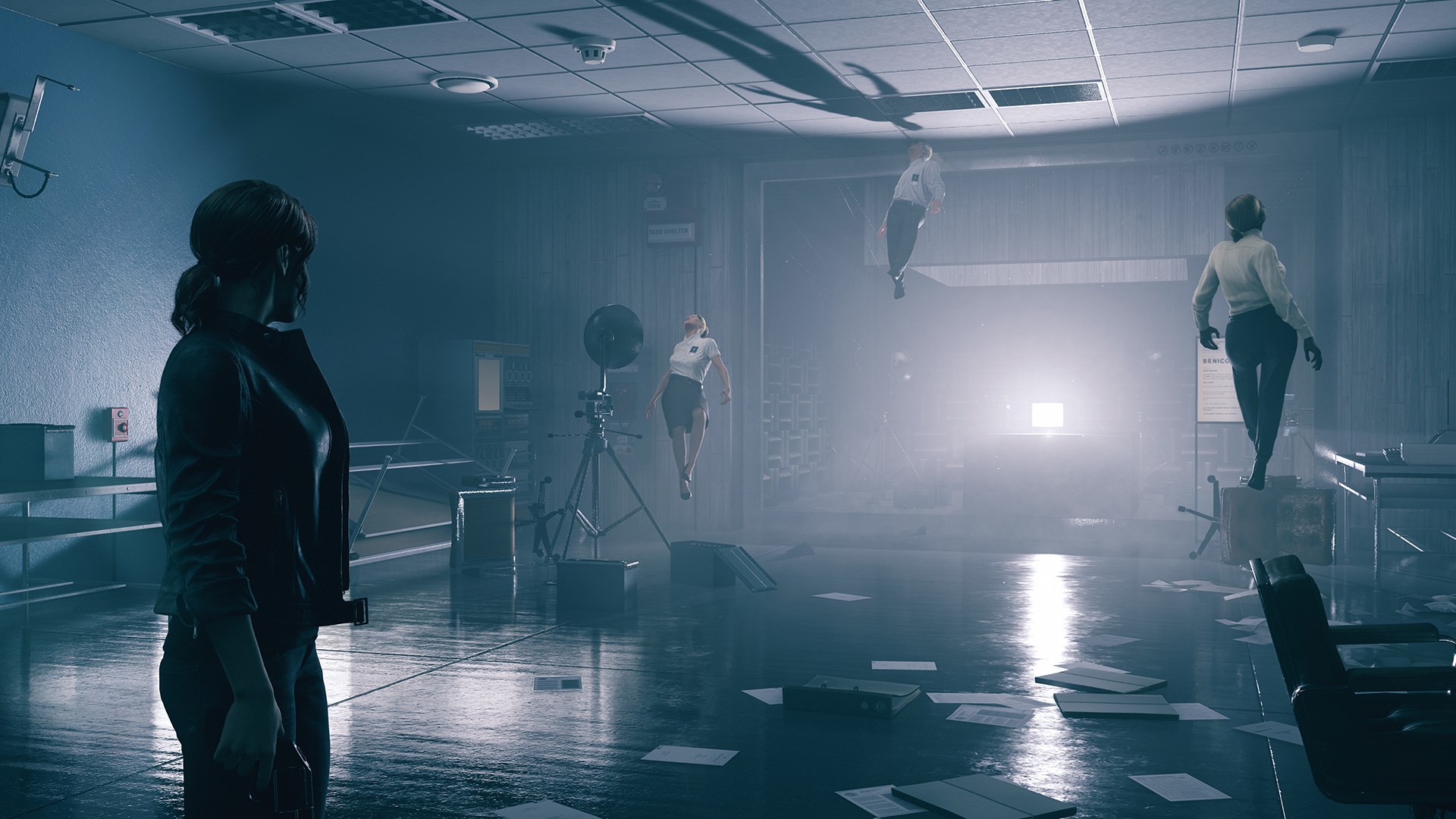 A screenshot from Control shows a character standing in a surreal, dimly lit corridor with distorted figures in the background.