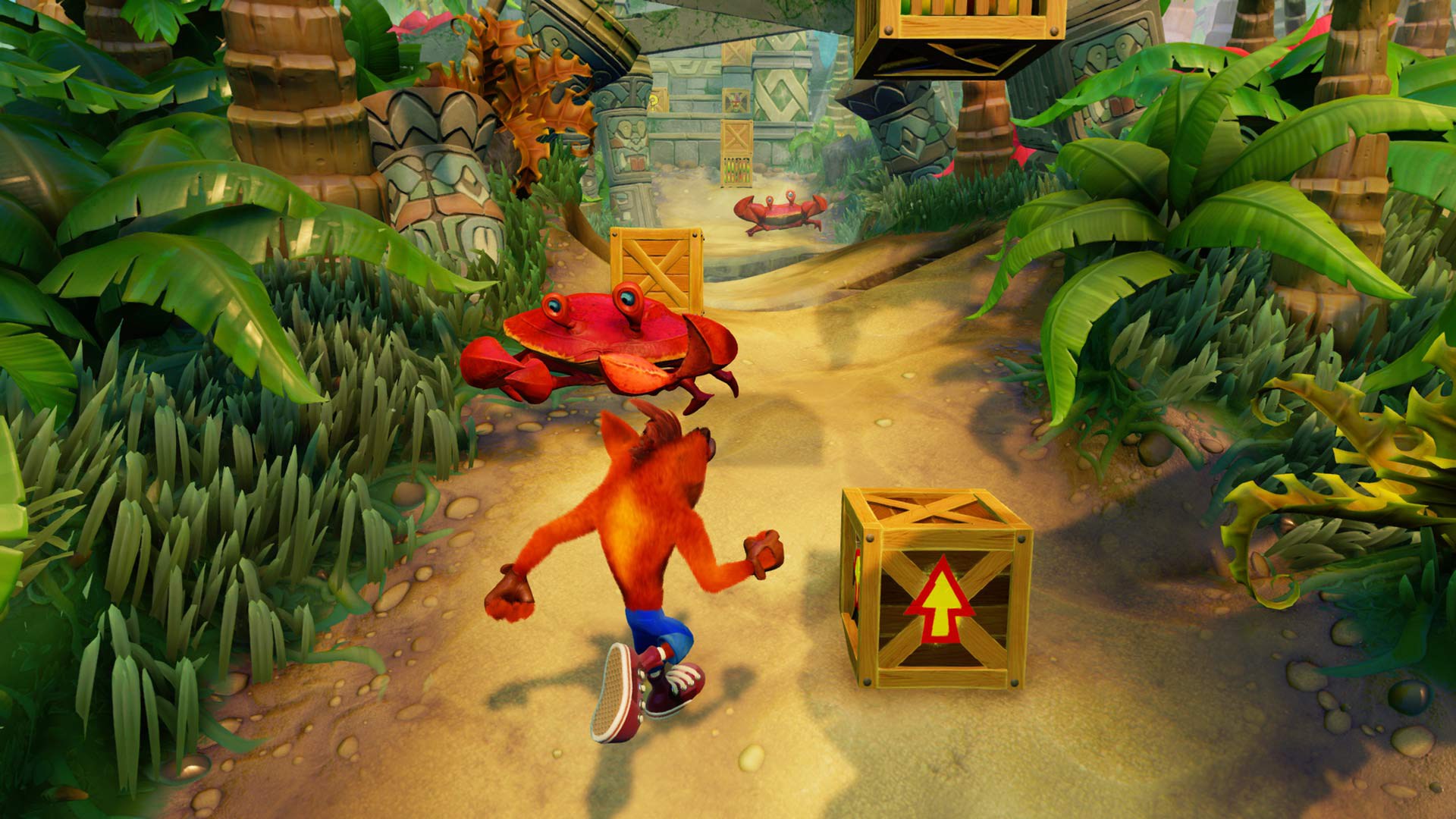A screenshot from Crash Bandicoot N. Sane Trilogy shows Crash running along a jungle path, avoiding a large red crab and jumping on boxes.