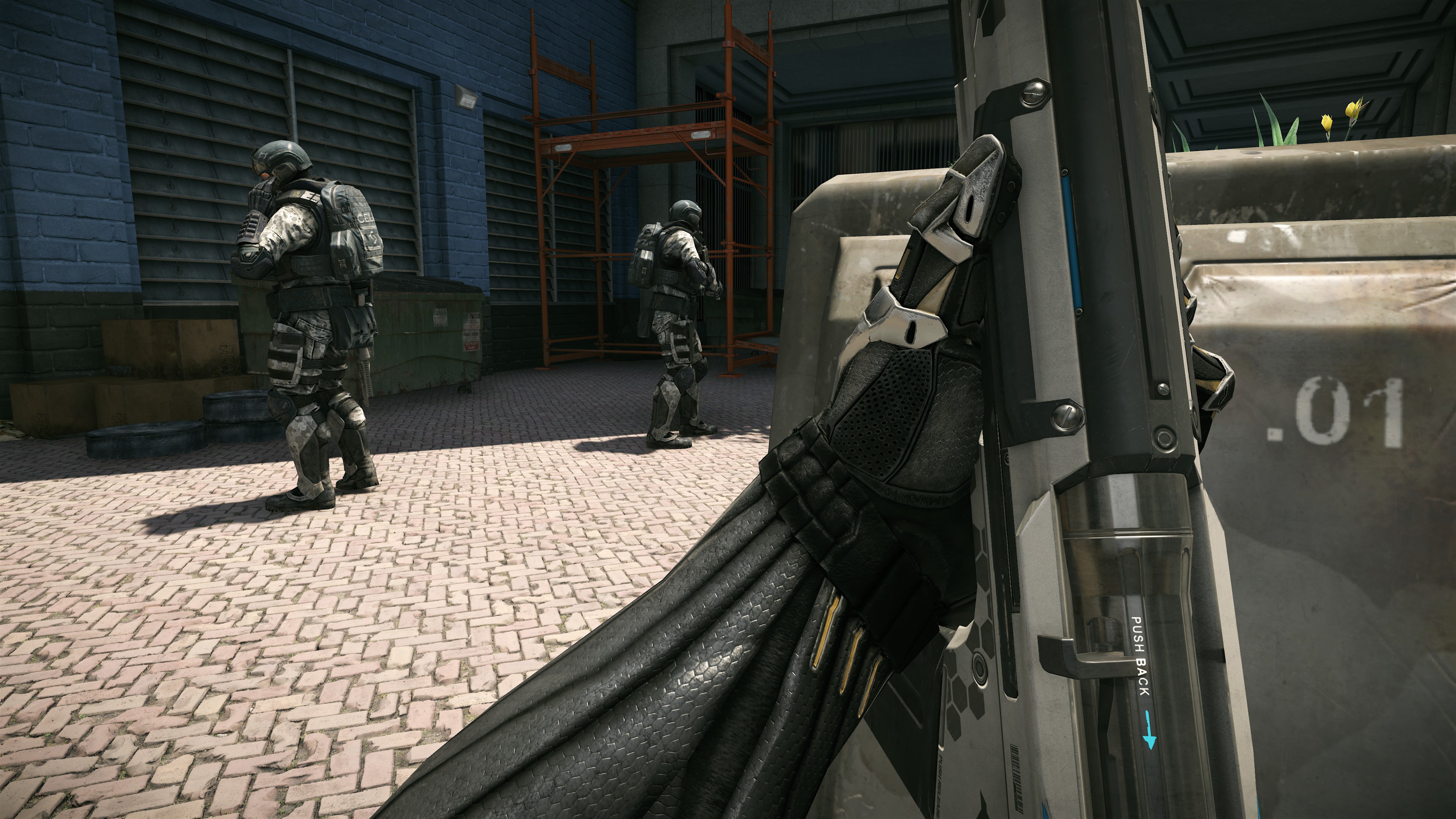 A screenshot from Crysis Remastered Trilogy shows a first-person view of a character holding a futuristic weapon, with two soldiers in tactical gear in front of a building.