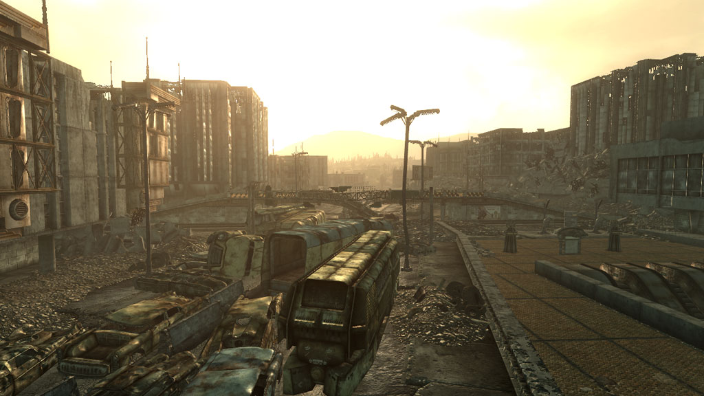A city skyline in Fallout 3, with a highway in the foreground piled with rusted abandoned cars and trucks (press kit).