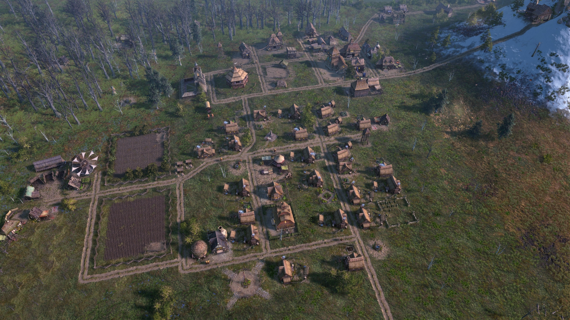 A village in Farthest Frontier: town center, some houses and a few small fields criss-crossed by dirt paths.