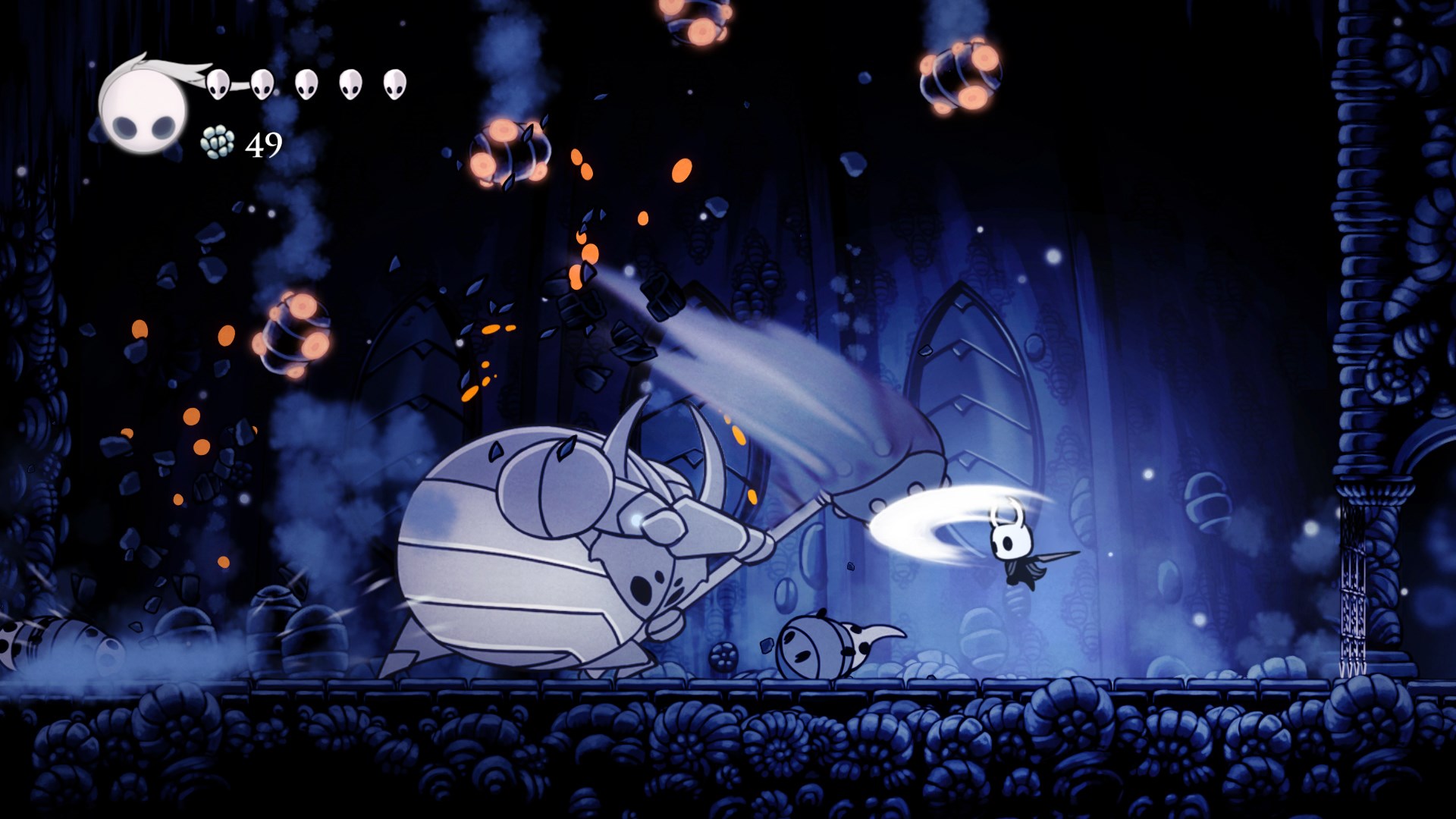 A screenshot from Hollow Knight shows the small insect knight character fighting a large, armored boss creature in a dark cave.