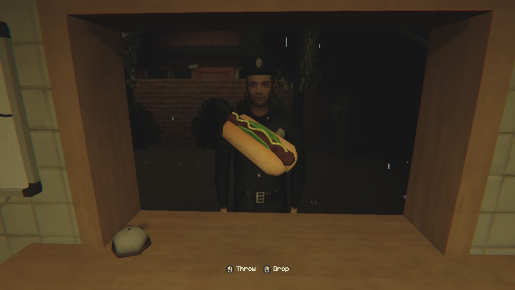 A customer at a kiosk with a hot dog in front of them.