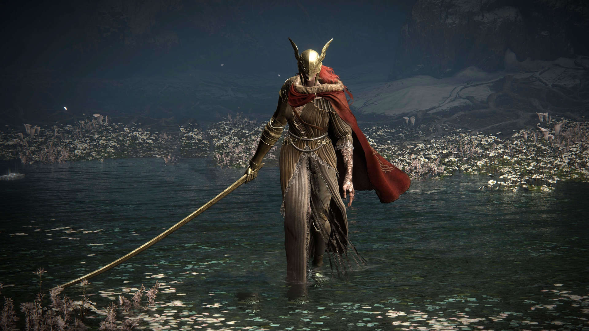 Elden Ring's Malenia, Blade of Miquella, stands in a shallow body of water filled with white flowers.