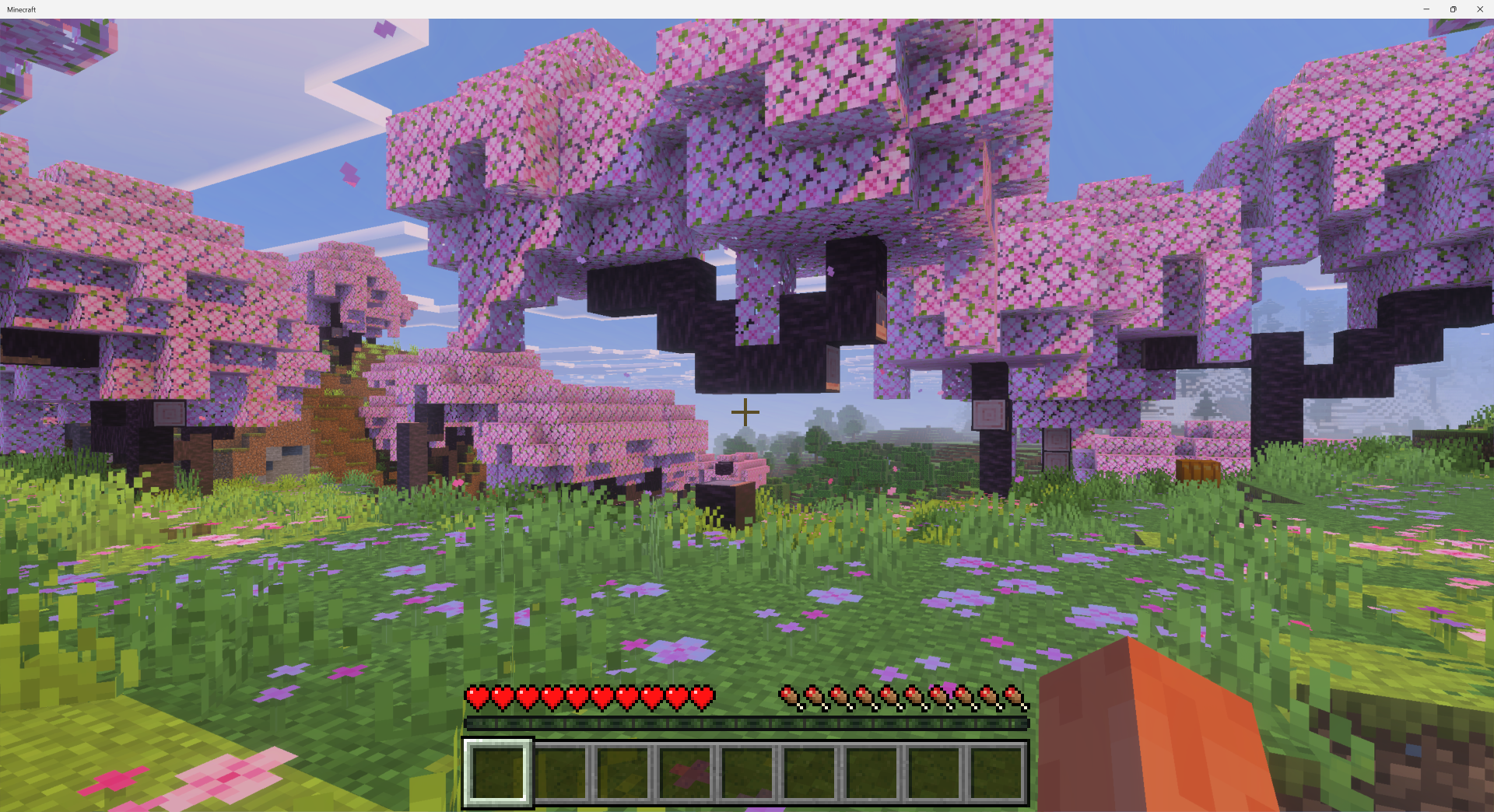 A cherry blossom tree in Minecraft floating in the air missing the bottom of its trunk.