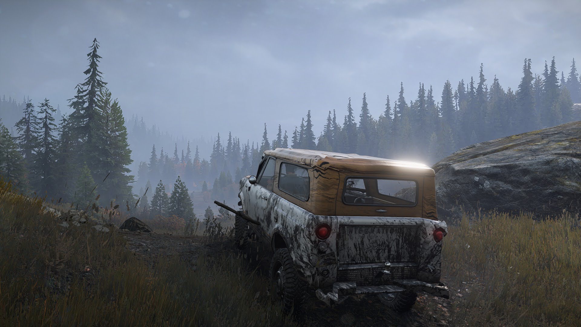 A beat-up off-road scout vehicle navigating rough terrain.