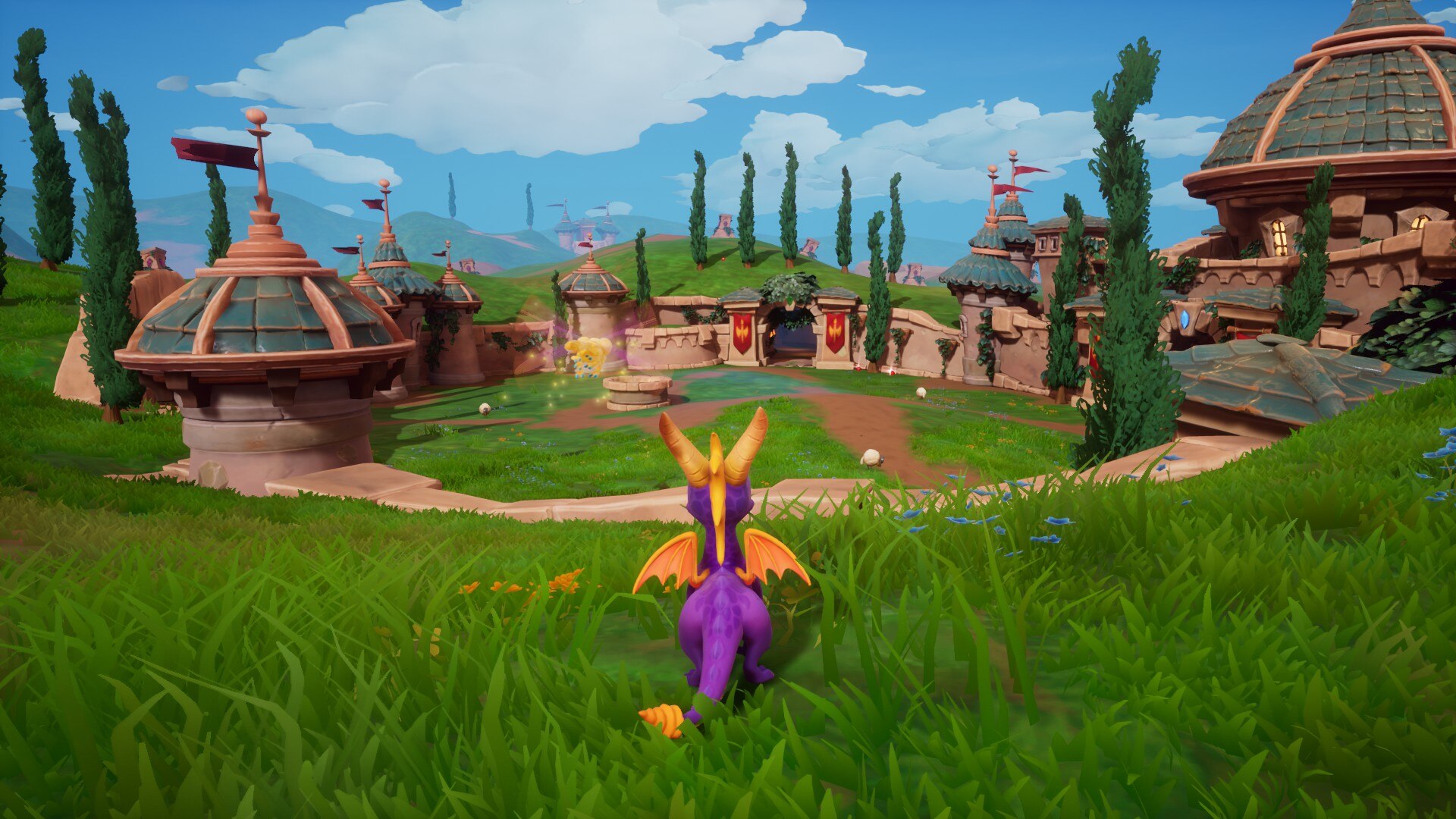 Spyro, the protagonist of Spyro Reignited (2018) trilogy, standing in front of rolling hills and castles.