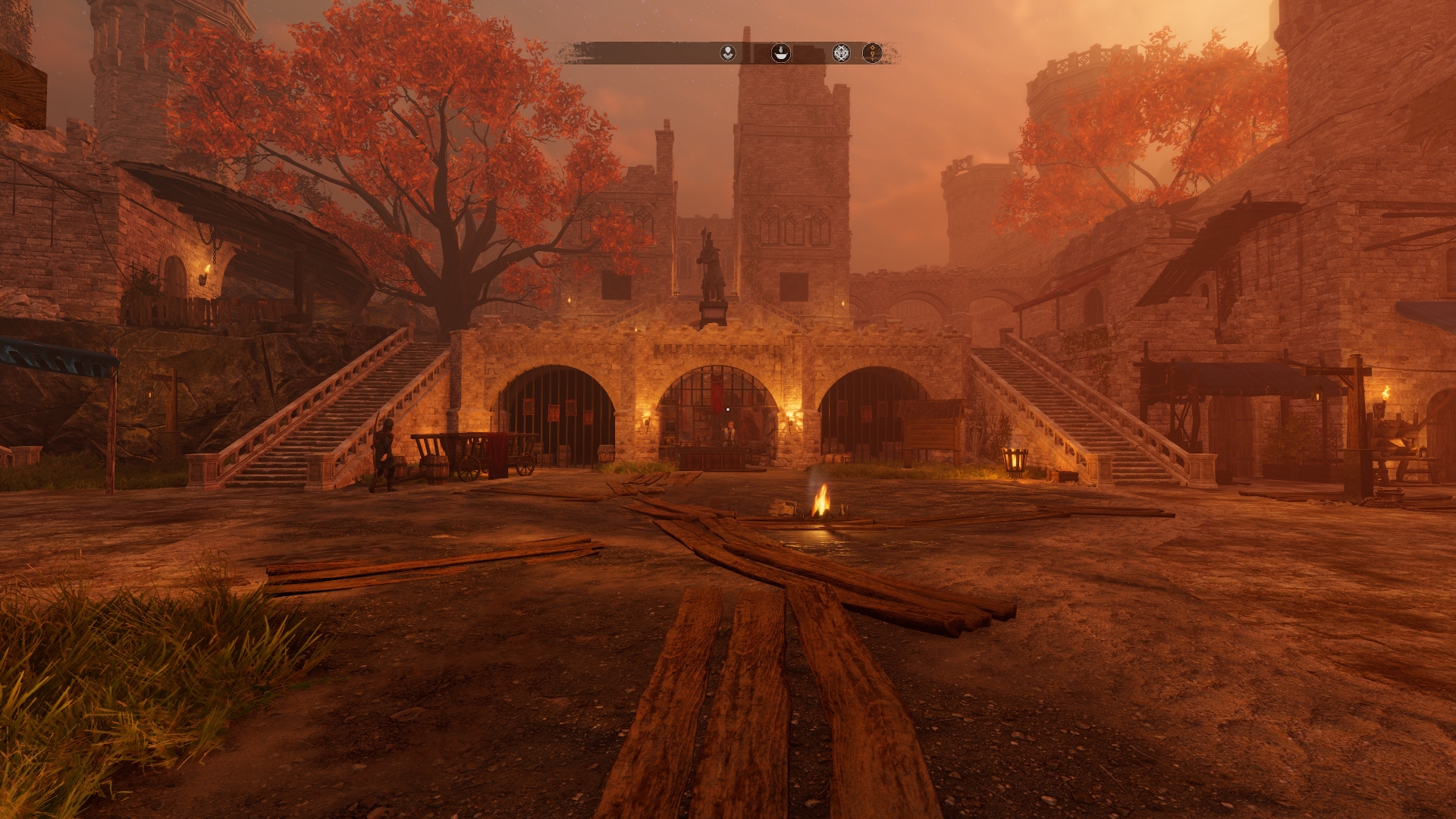 An interior yard of a castle at dusk - with some figures walking by the lit torches. Screenshot by author.