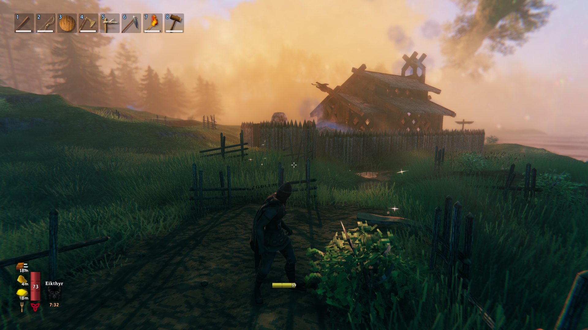 Valheim shows a character approaching a player-built house and fence under a misty, orange sunset.